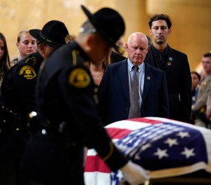 Mike Clinkunbroomer, center right, father of Los Angeles sheriff's deputy Ryan Clinkunbroomer watches as a flag is placed over his coffin during a funeral service at the Cathedral of Our Lady of the Angels Thursday, Oct. 5, 2023, in Los Angeles.
