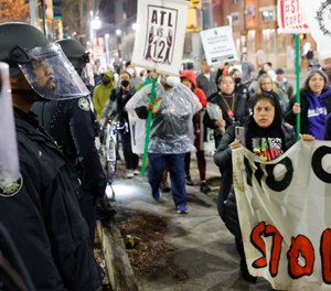 Demonstrators march near Atlanta police during a protest over plans to build a new police training center, Thursday, March 9, 2023, in Atlanta.