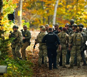 Law enforcement continue a manhunt in the aftermath of a mass shooting, in Durham, Maine, Friday, Oct. 27, 2023. Authorities are scouring hundreds of acres of family-owned property, sending dive teams to the bottom of a river and scrutinizing a possible suicide note in the second day of their intensive search for an Army reservist accused of fatally shooting several people in Maine.
