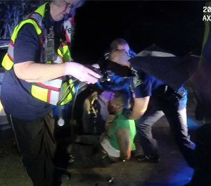 This image from video from Louisiana state trooper Lt. John Clary's body-worn camera shows troopers and medical personnel with Ronald Greene on May 10, 2019, outside of Monroe, La.