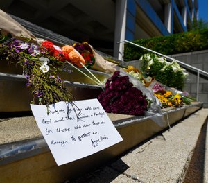 Flowers and a message of hope sit on the steps of the Old National Bank in Louisville, Ky., Tuesday, April 11, 2023.