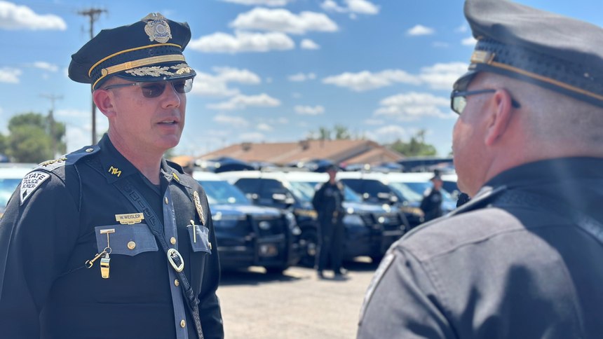 Chief Weisler at a District Meeting speaking with one of his officers.