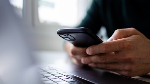 Close up on man hand using mobile phone