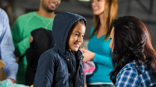 Little girl receives coat at charity clothing drive