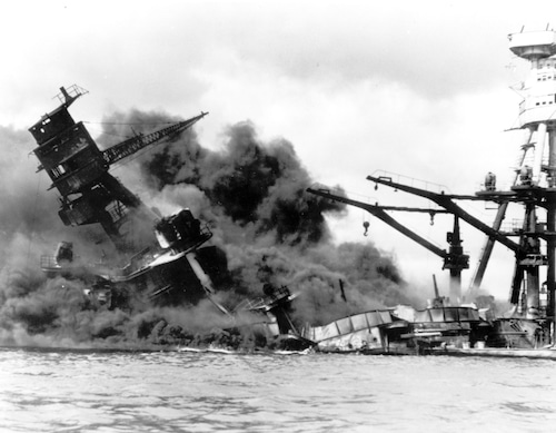 The battleship USS Arizona belches smoke as it topples over into the sea during a Japanese surprise attack on Pearl Harbor in Hawaii on Dec. 7, 1941.