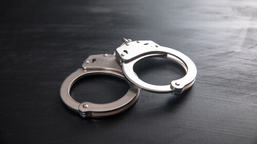 handcuffs on wooden background