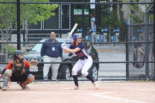 Brookline softball captain Cora Tracey hitting against Newton North.