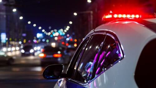police car lights in night city with selective focus and bokeh