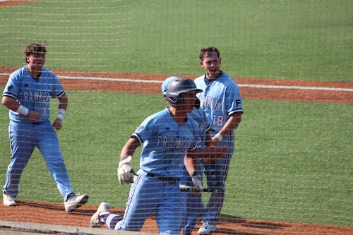 Franklin baseball celebrates scoring a run against Xaverian in the Division I state tournament.