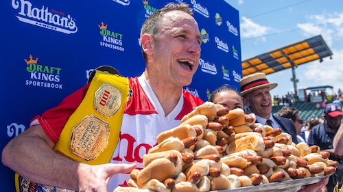 FILE - Joey Chestnut, winner of the 2021 Nathan's Famous Fourth of July International Hot Dog-Eating Contest, poses for photos in Coney Island's Maimonides Park, July 4, 2021, in the Brooklyn borough of New York.
