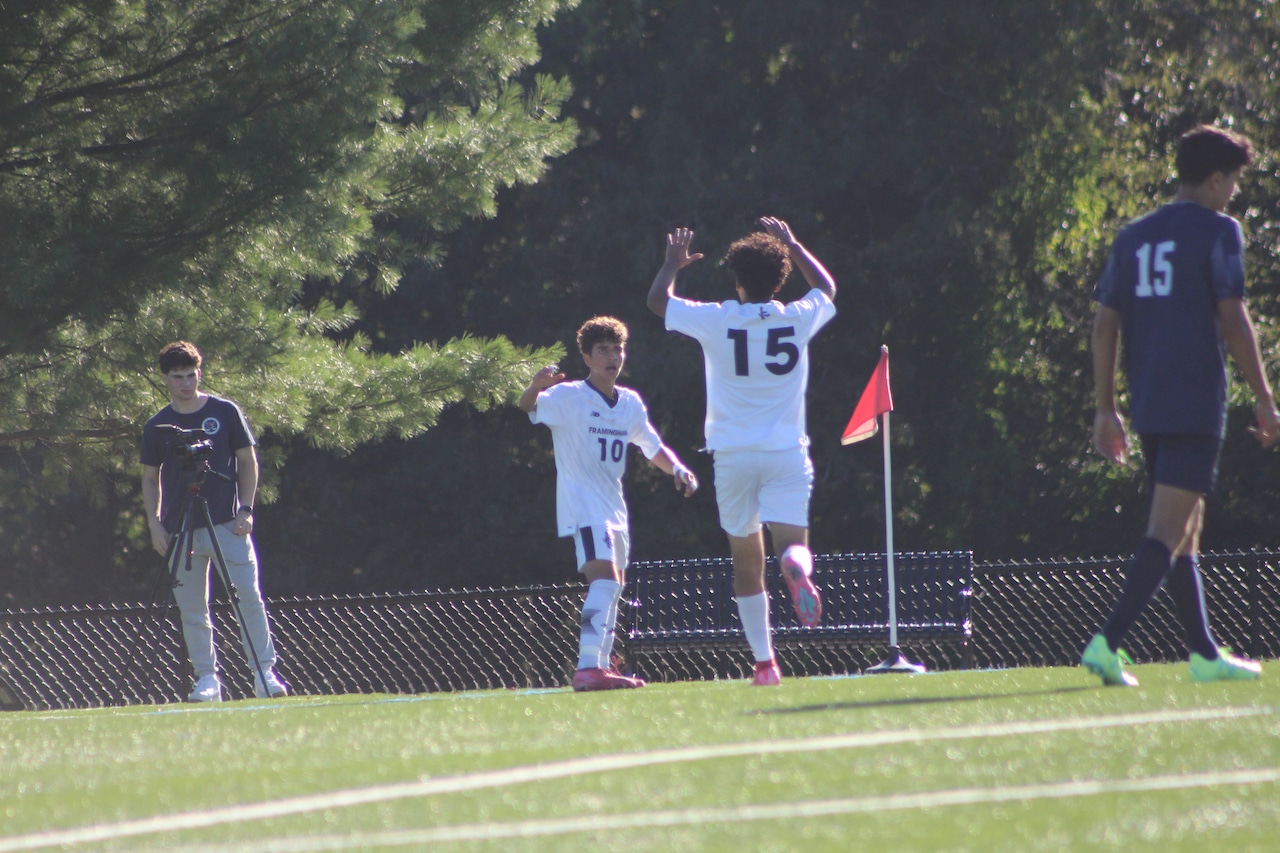 Bryan Santos (10) and Ryan Lopes (15) celebrate a goal for Framingham boys soccer against Brookline.