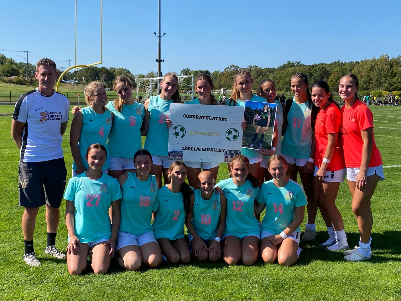The Southwick girls' soccer team celebrates Lorelai Whalley recording her 100th career point on 10/04/25.