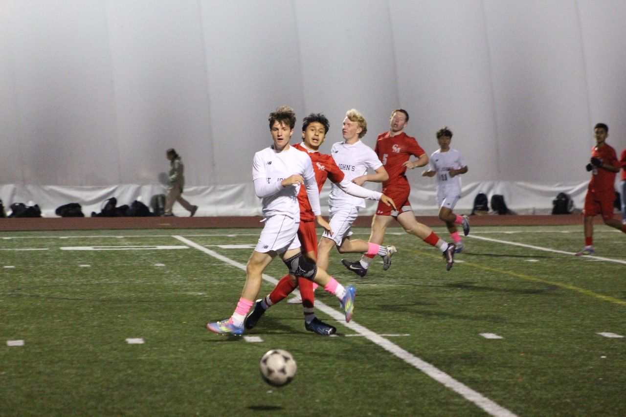 Ryan King passes the ball for St. John's Prep boys soccer in a game against Catholic Memorial.
