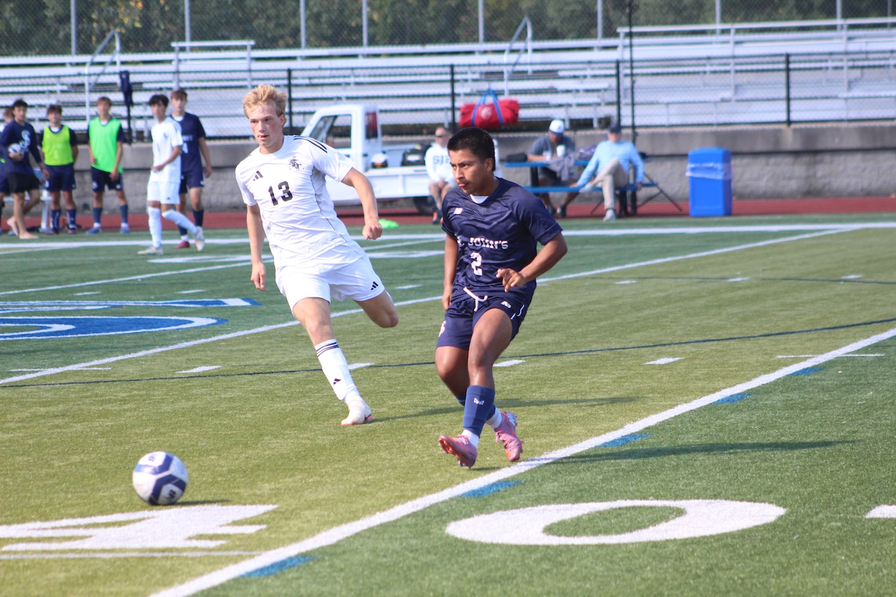 Gus Nugent makes a pass for St. John's Prep boys soccer in a match against Longmeadow.
