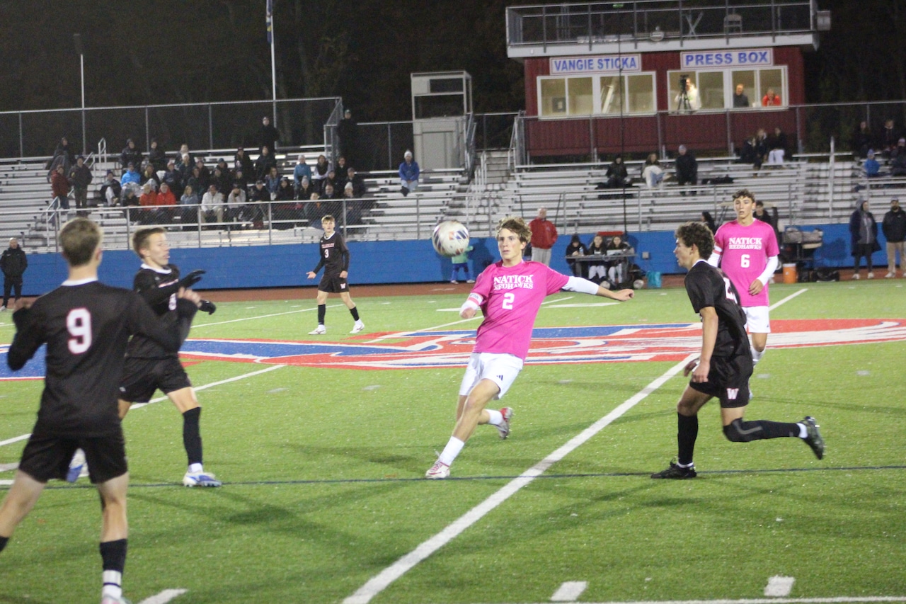 Luke Dougherty prepares to kick the ball for Natick boys soccer in a game against Wellesley.