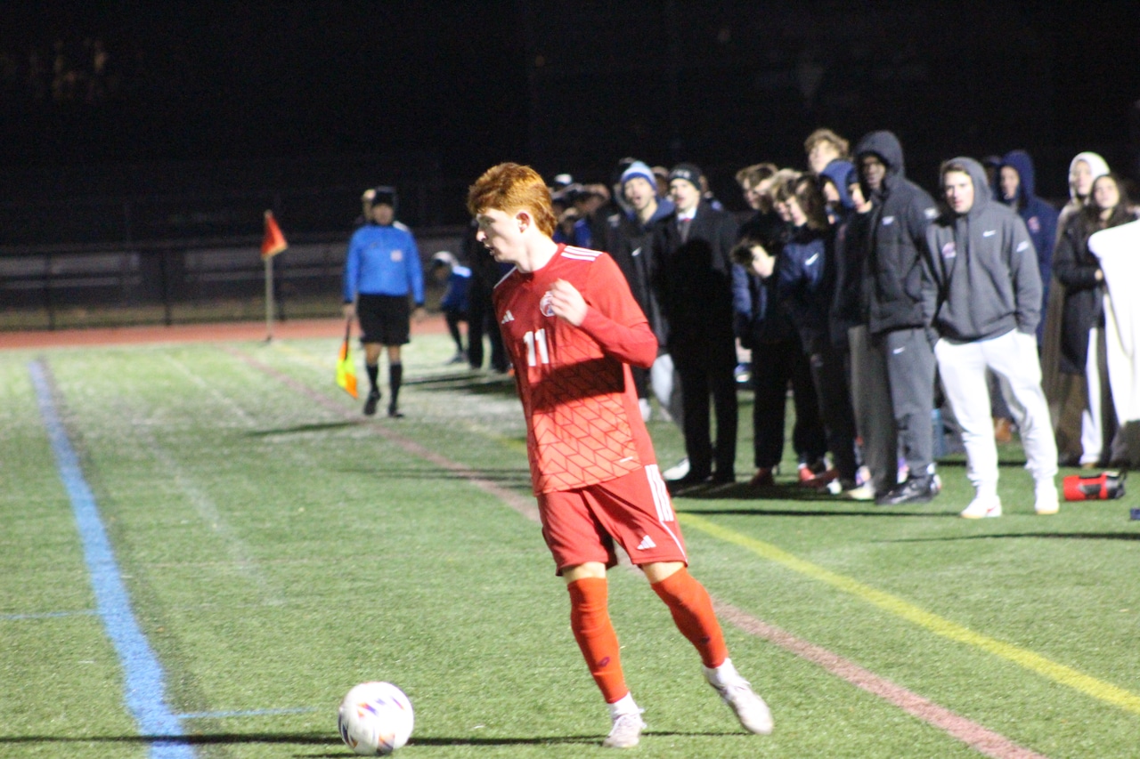 Cole Boggis dribbles the ball for Natick boys soccer in a match against Newton South.