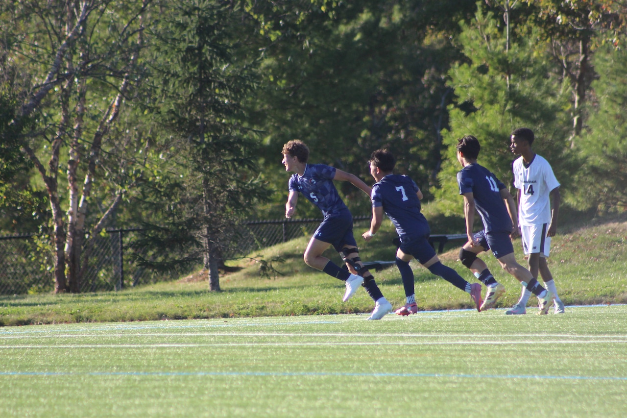 Adan Spivak (5) celebrates scoring a goal for Brookline boys soccer against Framingham.