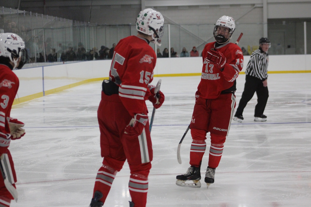 Mike Melvin (15) celebrates scoring for Catholic Memorial hockey against Belmont.