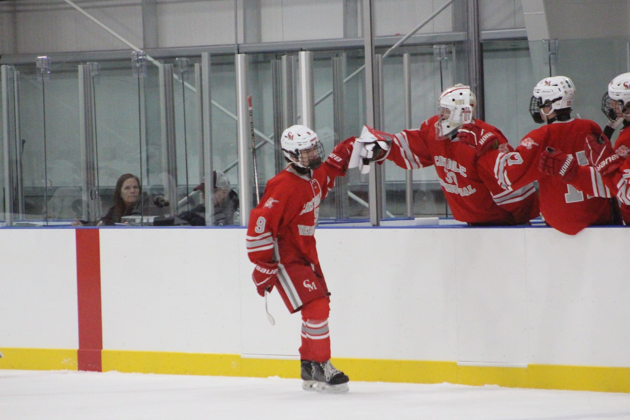 Shaun Farrell celebrates scoring his first varsity goal for Catholic Memorial hockey against Belmont.