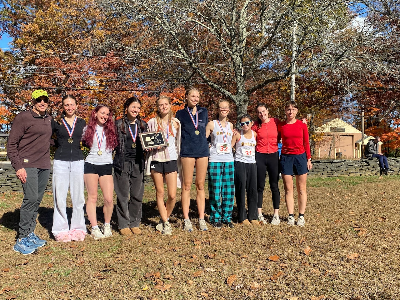 The Amherst girls' cross country team celebrates its first-place win on 10/26/25.